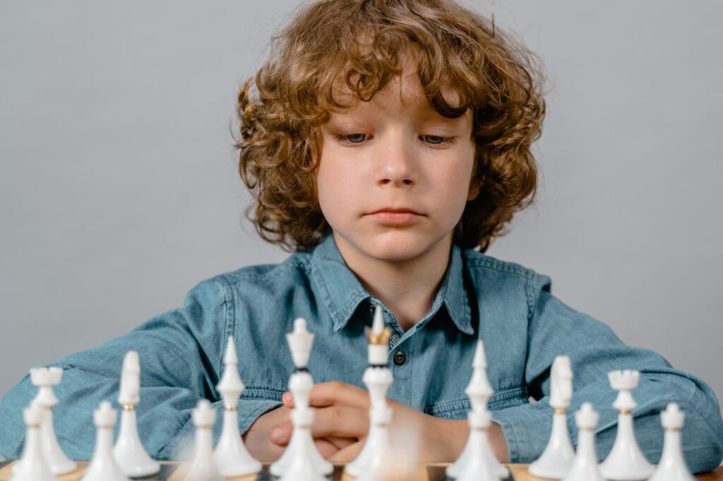 child learning critical thinking skills by playing chess